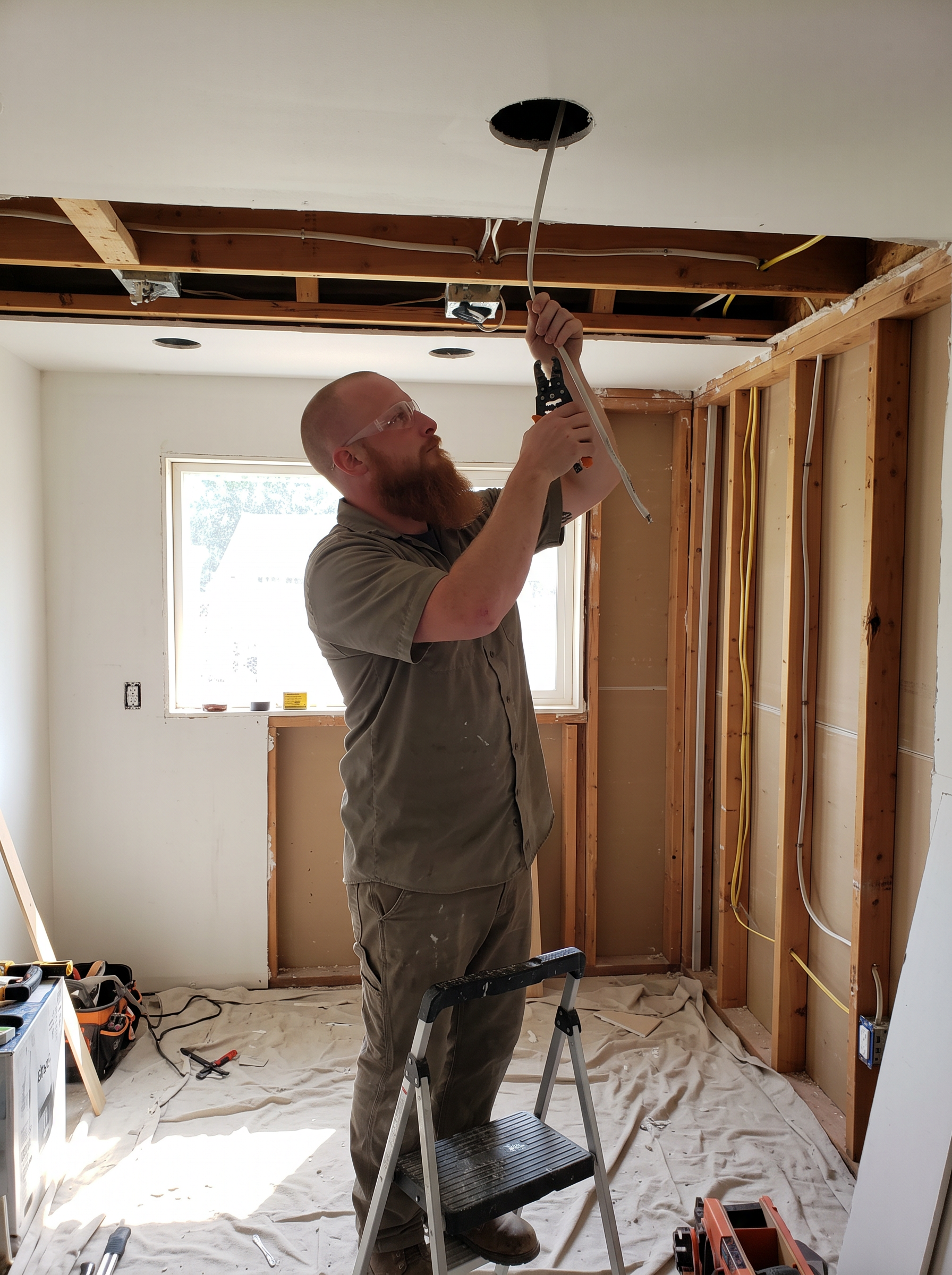Electrician installing lighting in a residential kitchen